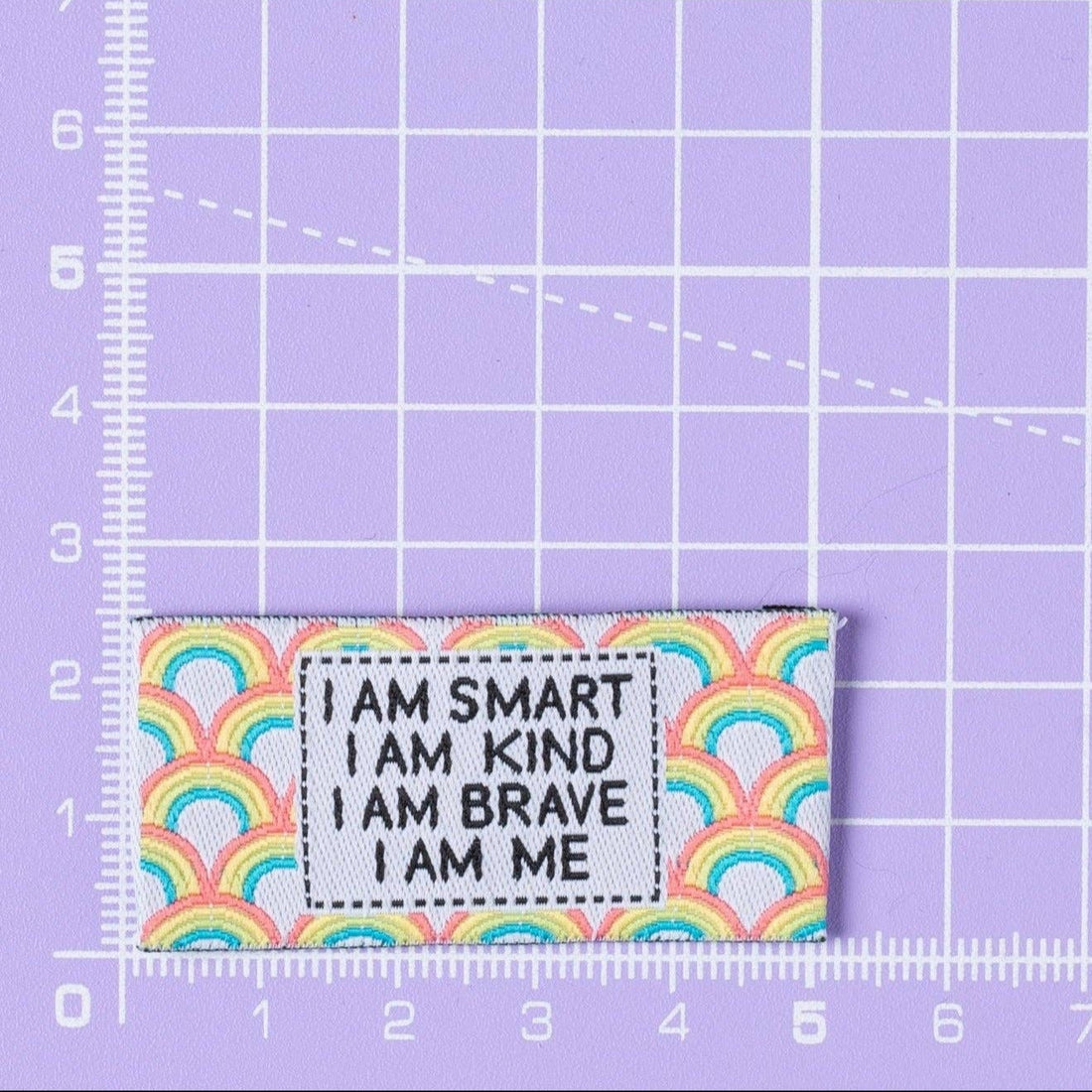 Motivational Sewing Label saying &quot; I am Smart, I am Kind, I am Brave, I am Me&quot; on a background of rainbows and colurs.
