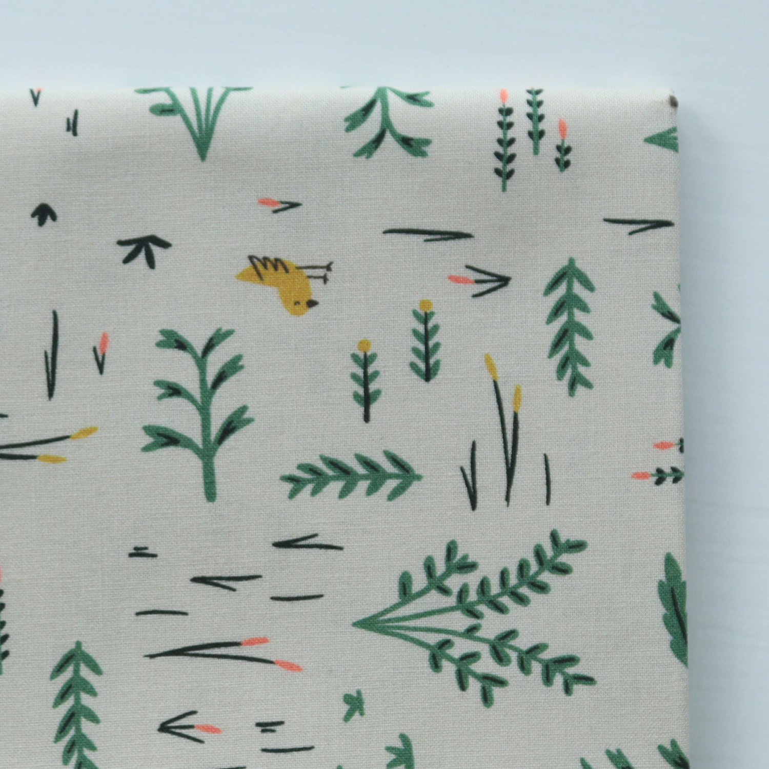 Fabric with nature-themed pattern featuring plants and a small animal on a light gray background
