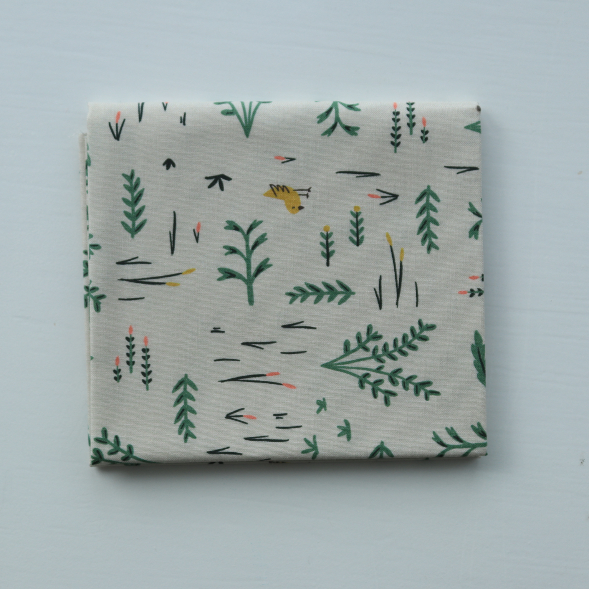Fabric with nature-themed pattern on a light gray background
