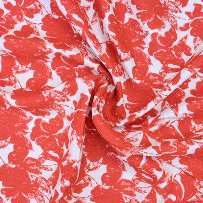 Red floral pattern on white fabric