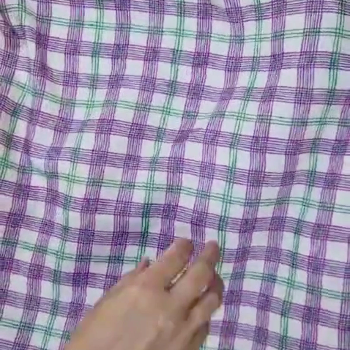 video of purple, green checked pattern, showing the movement and up close design