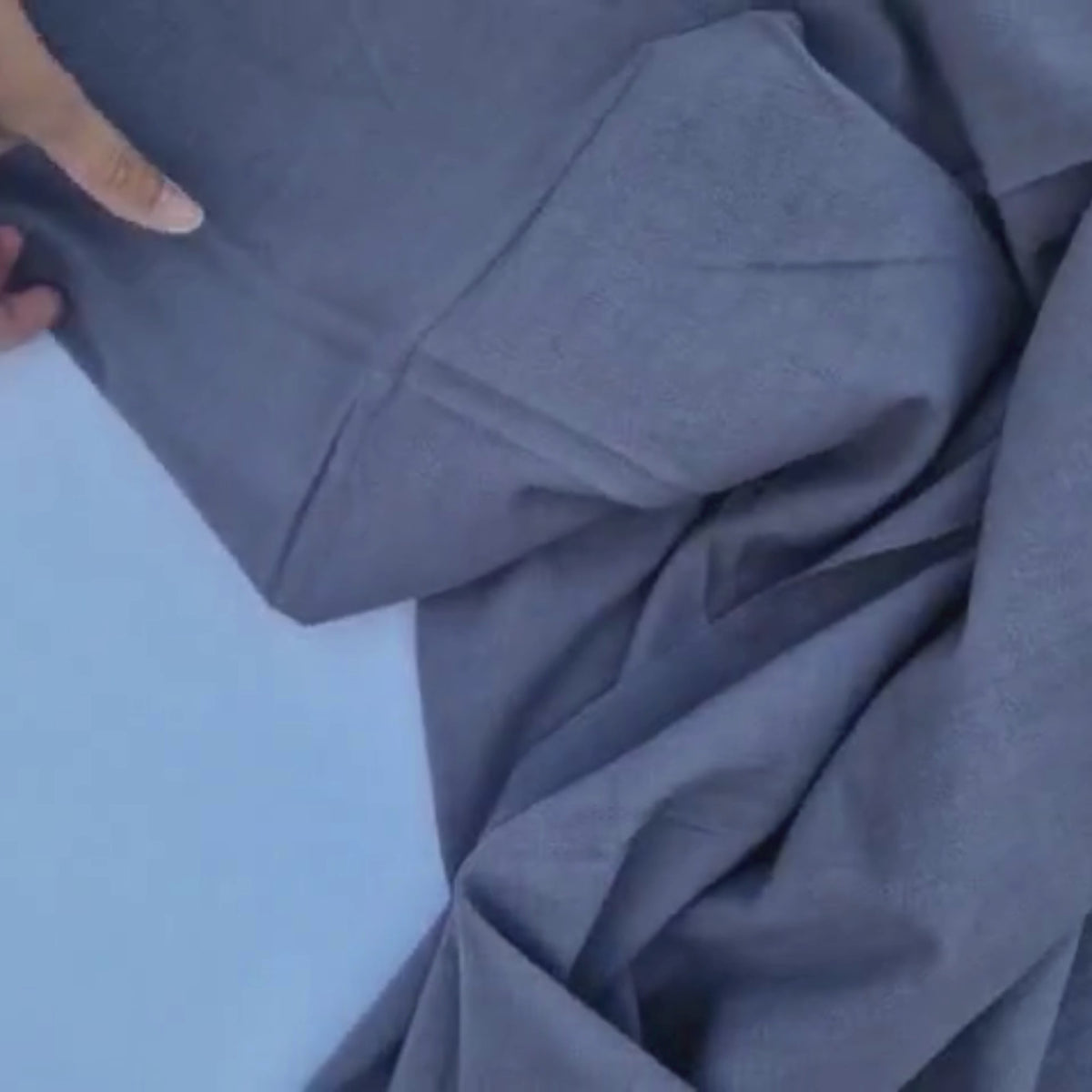 video of the dark grey vintage cotton fabric moving and showing up close the texture