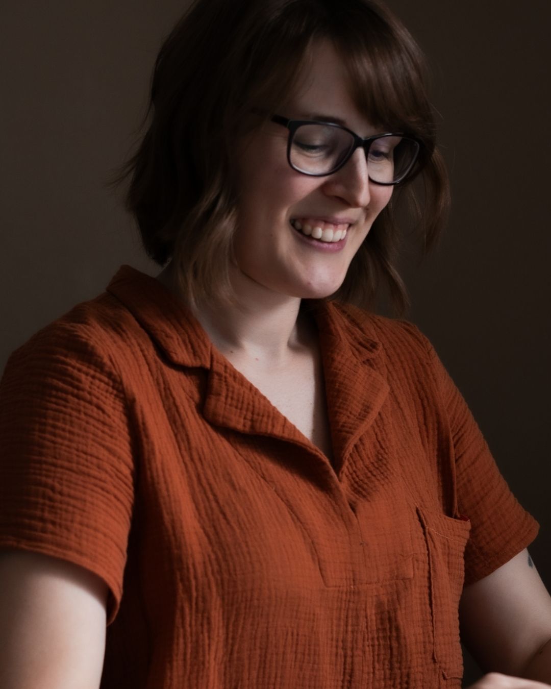 Rosie, founder of Sew Eco Fabrics, smiling in an orange handmade shirt made from double gauze fabric